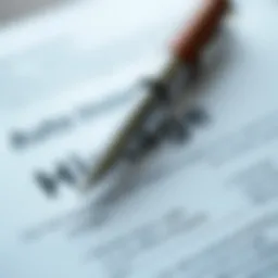 A close-up view of a car insurance policy document with a pen
